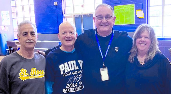 Joe Bozza, John Finley, Deacon Joseph Rafferty and Susan Miller gather in the St. Rose of Lima School gymnasium, which will be the venue for the first St. Rose reunion next Saturday. 