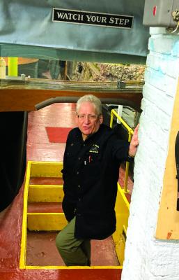 Mike Turan stands in a recessed well that facilitates passage under a section of the layout. 